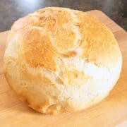 Entire loaf of artisan bread on a cutting board.